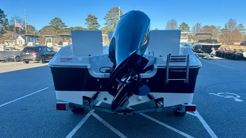 Slide: The Image of 2025 Bayliner T18 Limited Edition boat, rear view with outboard motor, parked outdoors. - 8
