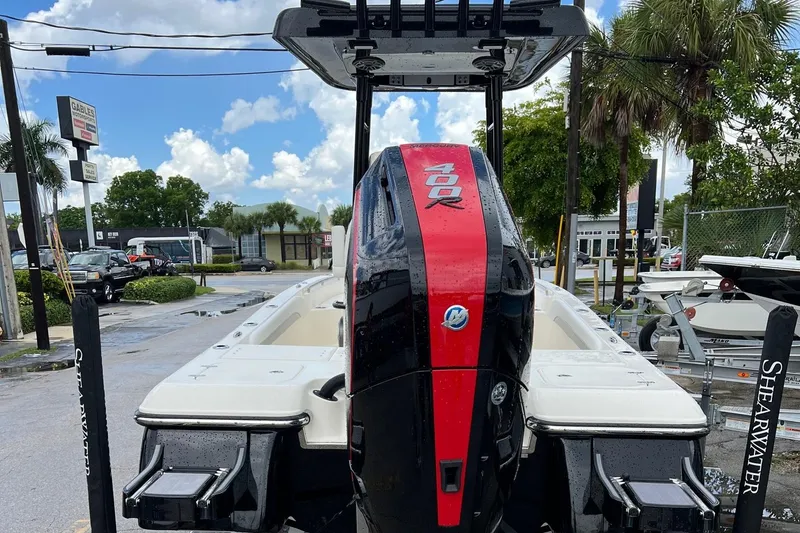 Slide: The Image of 2024 ShearWater 260 Carolina Flare boat with powerful outboard motor, parked outdoors. - 5