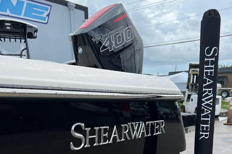 Slide: The Image of 2024 ShearWater 260 Carolina Flare boat with Racing 400 engine, docked outdoors. - 8
