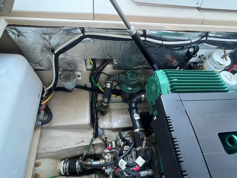 Slide: The Image of Engine compartment of a 2016 Cutwater C-28 boat, showcasing mechanical components and wiring. - 16