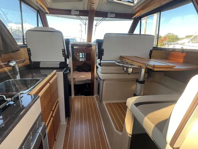Slide: The Image of Interior of 2016 Cutwater C-28 boat with modern kitchen and seating area. - 18