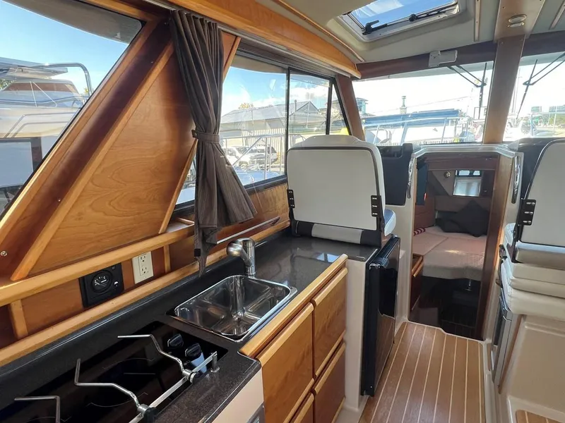 Slide: The Image of Interior of 2016 Cutwater C-28 boat with kitchen and seating area. - 19