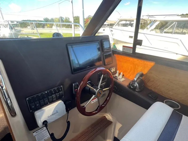 Slide: The Image of 2016 Cutwater C-28 helm with Garmin navigation, steering wheel, and control panel. - 26