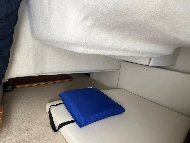 Slide: The Image of Interior cabin of 2016 Cutwater C-28 boat with blue cushion on beige seating. - 33