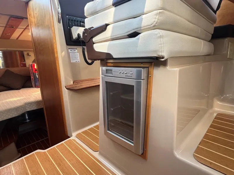 Slide: The Image of 2016 Cutwater C-28 interior with compact fridge and cozy cabin seating. - 37