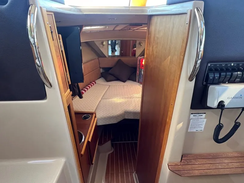 Slide: The Image of Interior cabin of 2016 Cutwater C-28 boat with cozy bed and wooden accents. - 39
