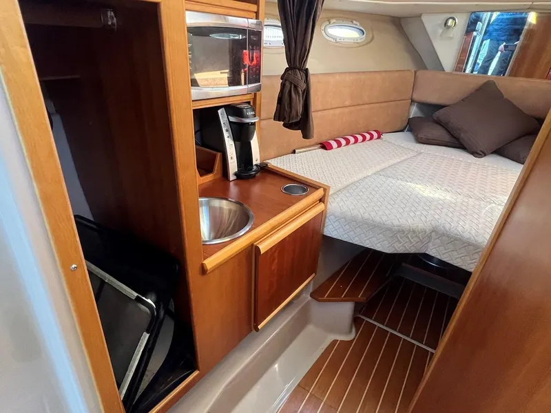 Slide: The Image of 2016 Cutwater C-28 cabin interior with kitchenette and cozy sleeping area. - 40