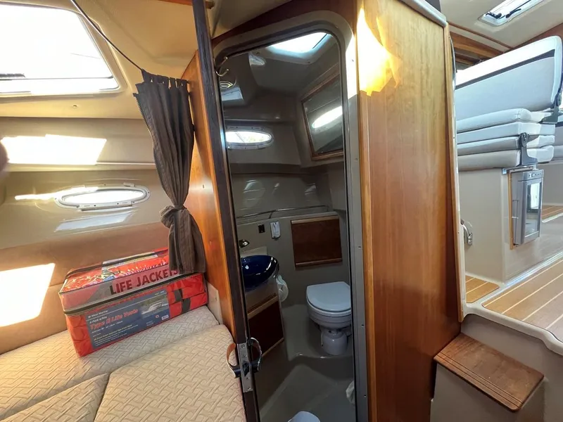 Slide: The Image of Interior of 2016 Cutwater C-28 boat with bathroom, bed, and life jackets. - 48