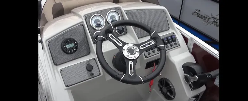 Slide: The Image of 2025 Starcraft EX 22 Q boat dashboard with steering wheel and control panel. - 10