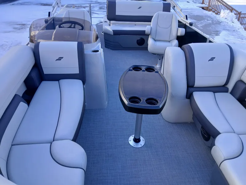 Slide: The Image of 2025 Starcraft EX 22 Q boat interior with plush seating and central table. - 3