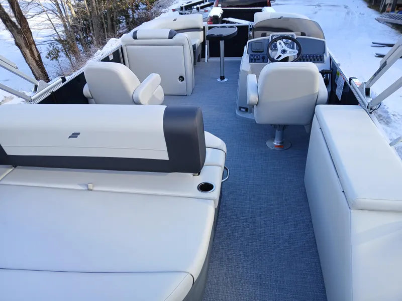Slide: The Image of 2025 Starcraft EX 22 Q pontoon boat interior with plush seating and modern helm. - 4