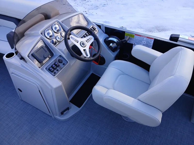 Slide: The Image of 2025 Starcraft EX 22 Q boat helm with modern controls and comfortable captain's chair. - 6