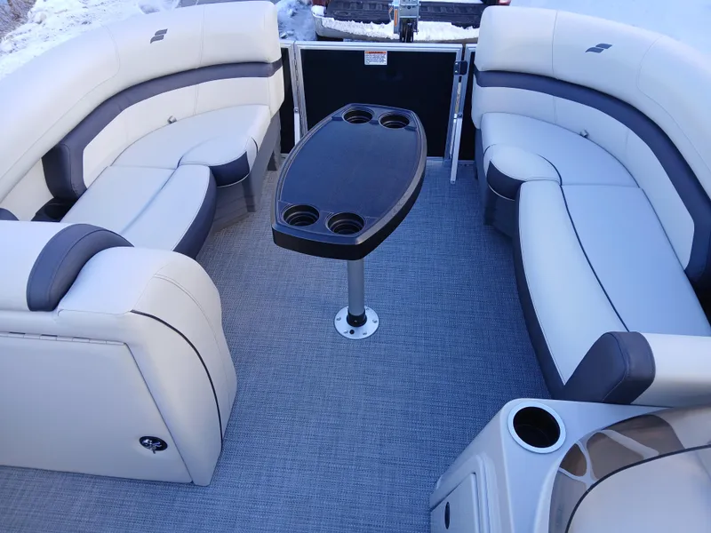 Slide: The Image of 2025 Starcraft EX 22 Q boat interior with plush seating and central table. - 7