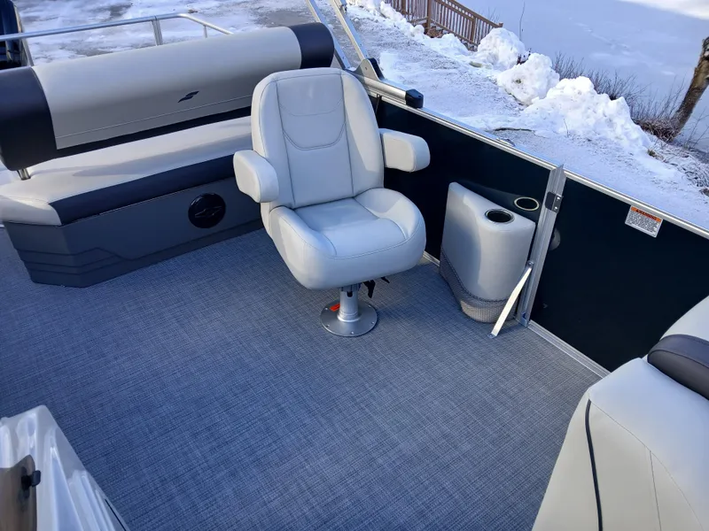 Slide: The Image of Starcraft EX 22 Q 2025 boat interior with seating and snowy background. - 8