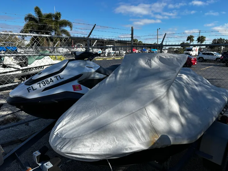 Slide: The Image of Two jet skis, one covered, parked outdoors; 2022 Orca Carbon model visible. - 3