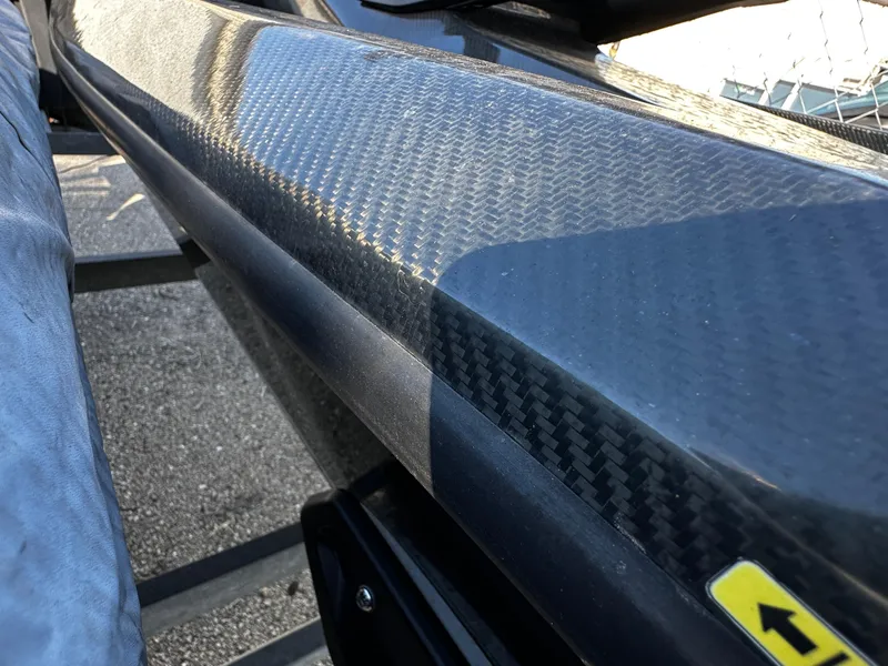 Slide: The Image of Close-up of 2022 Orca Carbon kayak with sleek carbon fiber finish. - 6