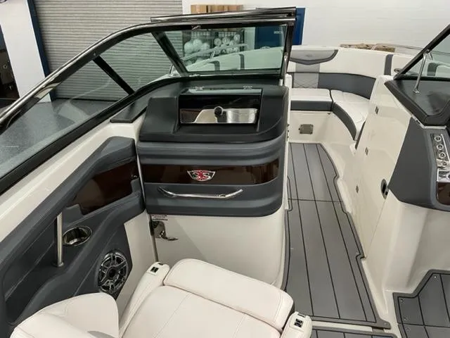 Slide: The Image of 2021 Chaparral 267 SSX OB boat interior with sleek seating and modern dashboard. - 10