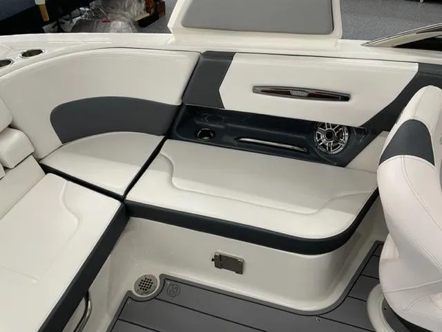 Slide: The Image of 2021 Chaparral 267 SSX OB boat interior with white and gray seating. - 13