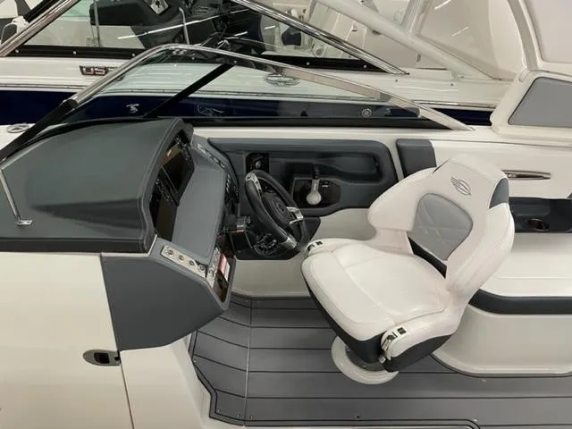 Slide: The Image of 2021 Chaparral 267 SSX OB boat interior with sleek helm and comfortable captain's chair. - 7