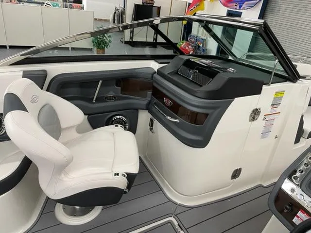 Slide: The Image of 2021 Chaparral 267 SSX OB boat interior with captain's chair and dashboard. - 9