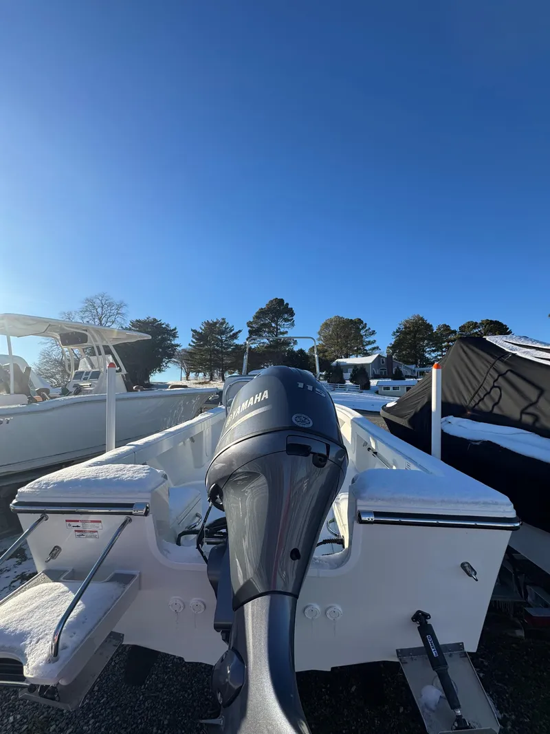 Slide: The Image of 2025 Parker 18SE Center Console boat cruising on a lake with two passengers. - 3