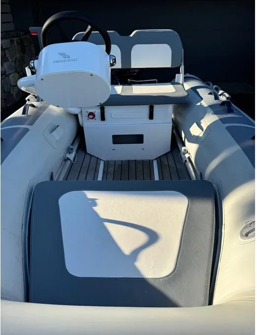 Slide: The Image of 2023 Highfield Classic 310 FCT boat interior with steering console and seating. - 4