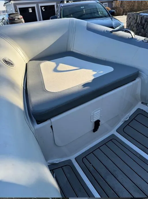 Slide: The Image of 2023 Highfield Classic 310 FCT boat interior with cushioned seating and storage compartment. - 5