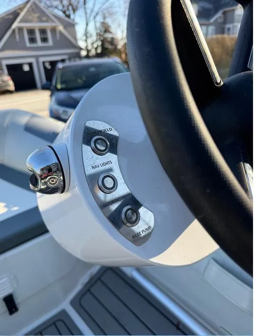 Slide: The Image of Close-up of 2023 Highfield Classic 310 FCT boat controls and steering wheel. - 8