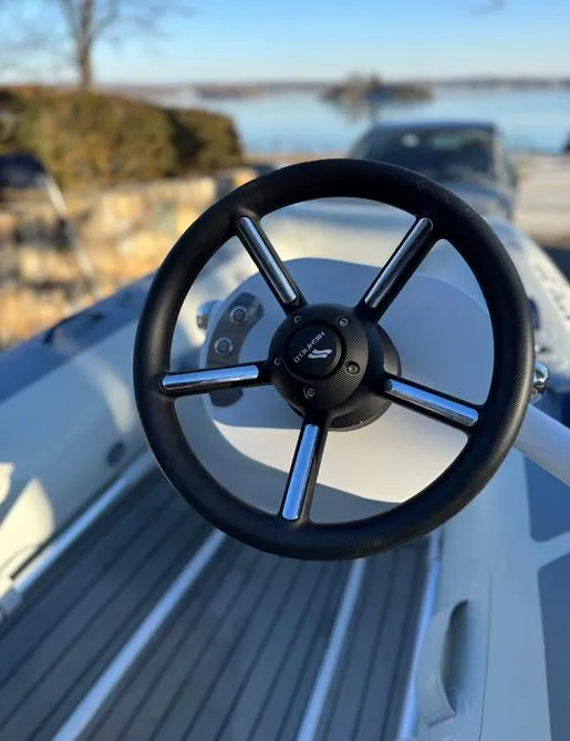 Slide: The Image of Steering wheel of 2023 Highfield Classic 310 FCT boat, close-up view. - 9