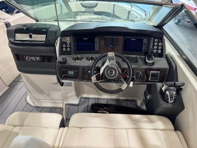 Slide: The Image of 2022 Chaparral 280 OSX boat cockpit with modern controls and steering wheel. - 11