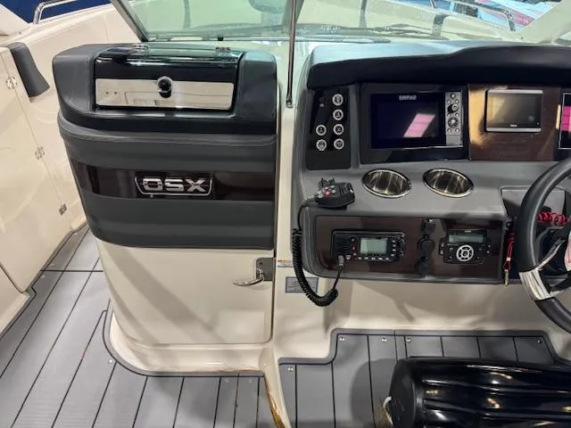 Slide: The Image of 2022 Chaparral 280 OSX boat dashboard with modern controls and navigation equipment. - 16