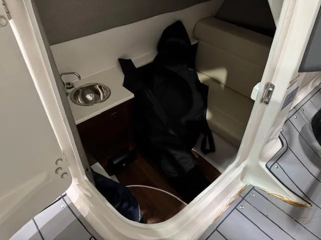 Slide: The Image of 2022 Chaparral 280 OSX cabin interior with sink and seating area. - 17