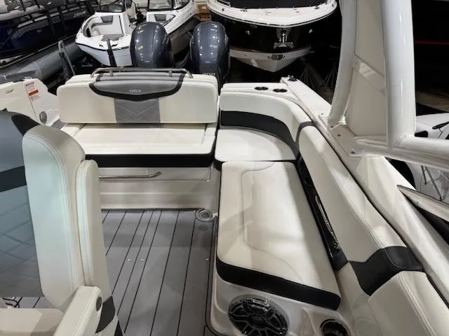 Slide: The Image of 2022 Chaparral 280 OSX boat interior with white seating and modern design. - 18