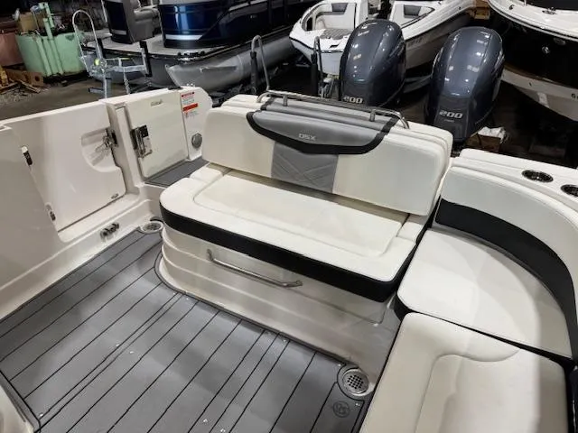Slide: The Image of 2022 Chaparral 280 OSX boat interior with seating and dual engines. - 19