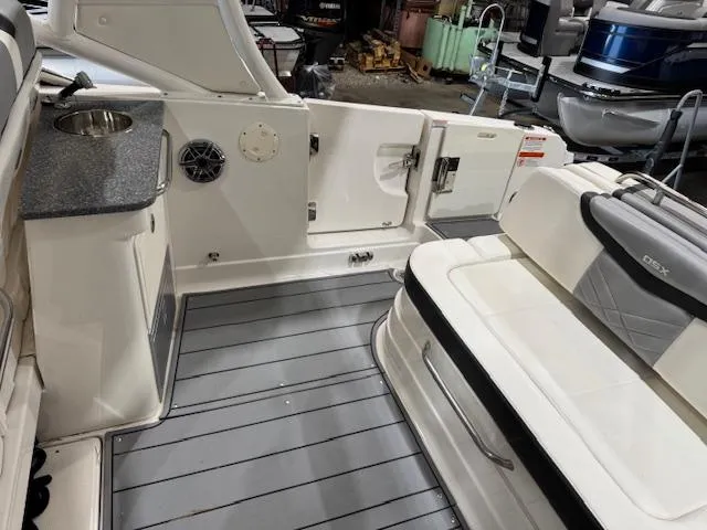 Slide: The Image of 2022 Chaparral 280 OSX boat interior with seating and kitchenette area. - 20