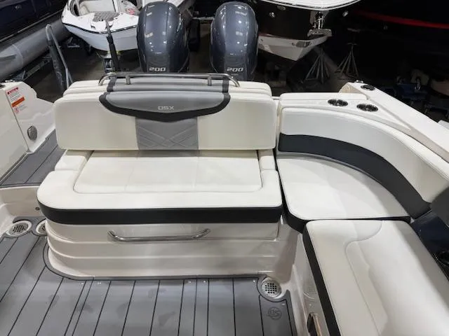 Slide: The Image of 2022 Chaparral 280 OSX boat interior with white seating and dual engines. - 25