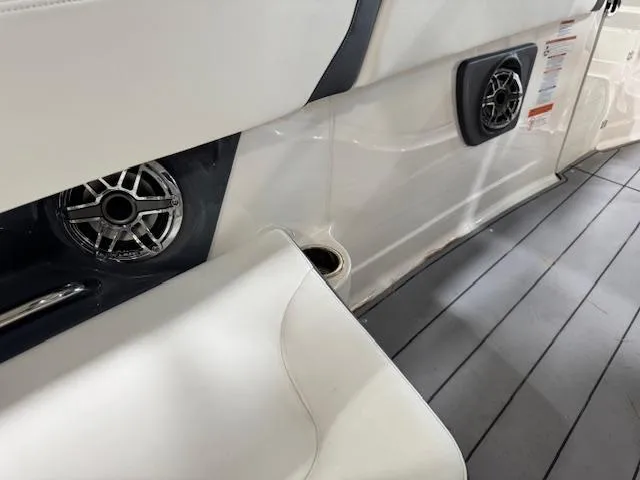 Slide: The Image of 2022 Chaparral 280 OSX boat interior with speakers and seating on sleek flooring. - 30