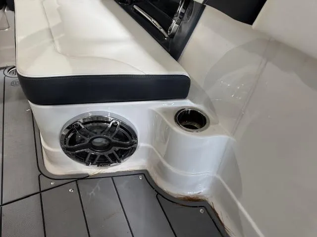 Slide: The Image of 2022 Chaparral 280 OSX boat interior with speaker and cup holder. - 31