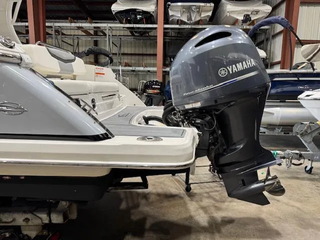Slide: The Image of 2022 Chaparral 280 OSX boat with Yamaha outboard motor in storage facility. - 33