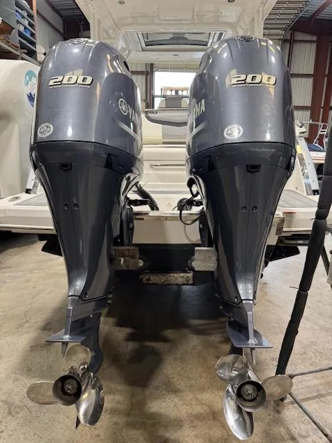 Slide: The Image of 2022 Chaparral 280 OSX with twin Yamaha 200 outboard engines in a boatyard. - 34