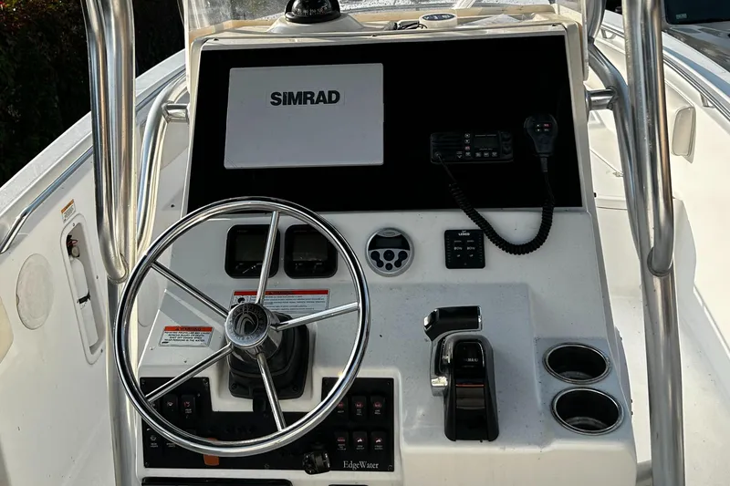 Slide: The Image of Edgewater 228CC 2010 boat console with Simrad display and steering wheel. - 11
