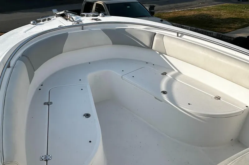 Slide: The Image of 2010 Edgewater 228CC boat deck with seating and storage compartments. - 14