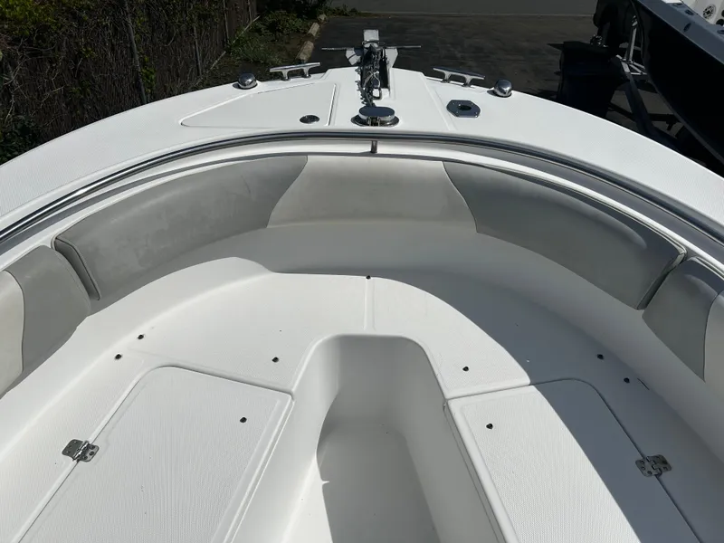 Slide: The Image of Bow seating area of a 2010 Edgewater 228CC boat with cushioned seats. - 16