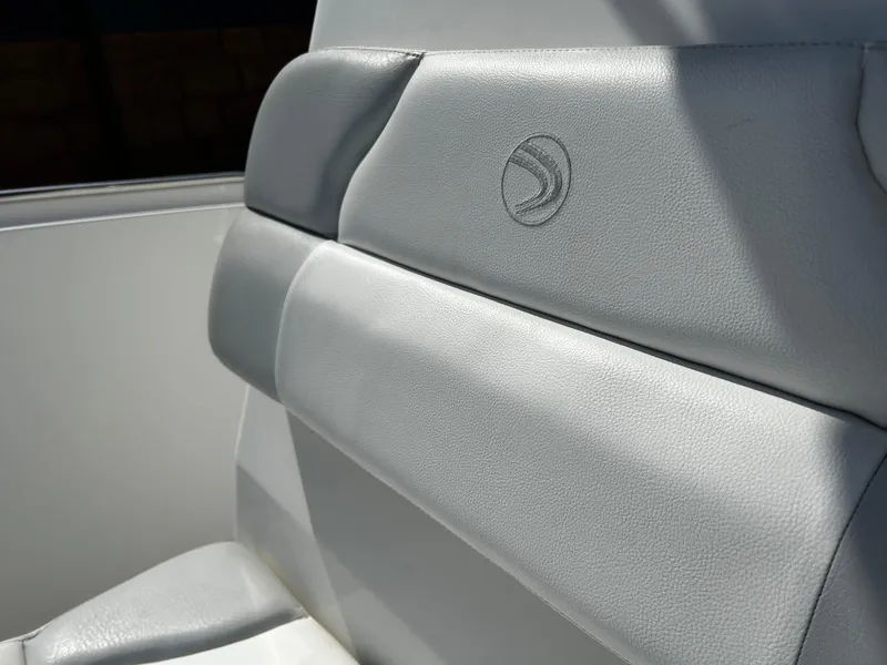 Slide: The Image of Gray leather seat on 2010 Edgewater 228CC boat, featuring embossed logo. - 18