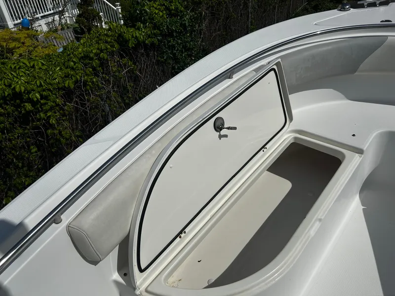 Slide: The Image of 2010 Edgewater 228CC boat storage compartment open, showcasing interior space. - 19