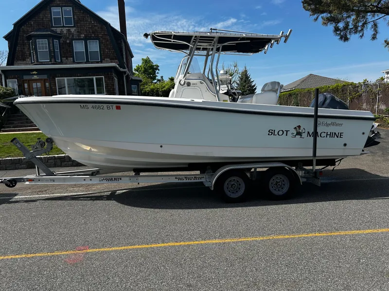 Slide: The Image of 2010 Edgewater 228CC boat on trailer, parked on street near house. - 5