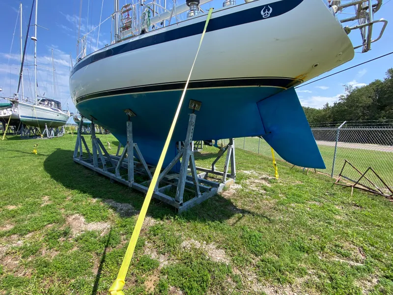 Slide: The Image of 1972 Ericson 39 Flushdeck sailboat on stands, displayed outdoors. - 12
