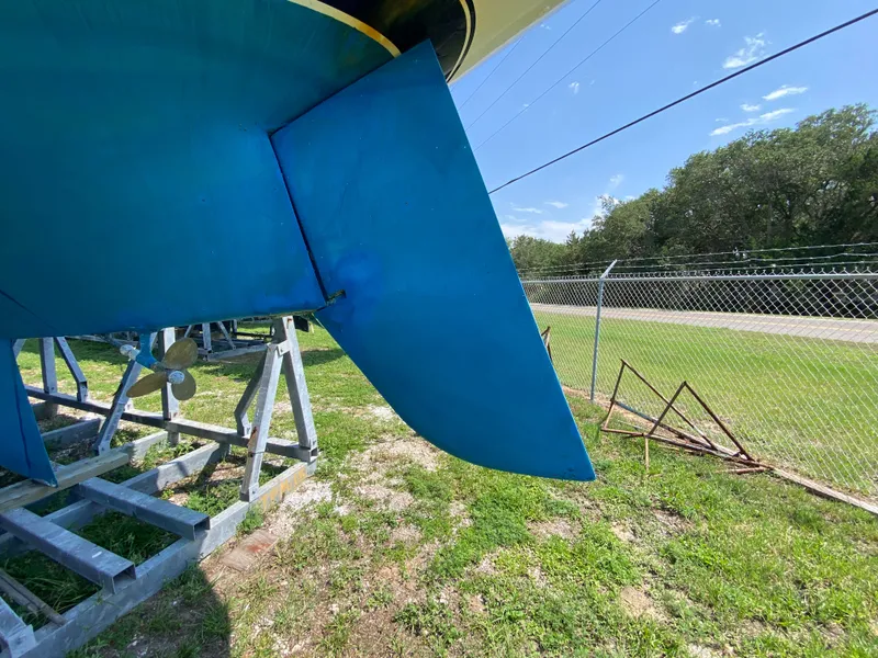 Slide: The Image of Ericson 39 Flushdeck 1972 sailboat rudder and propeller on land, sunny day. - 15