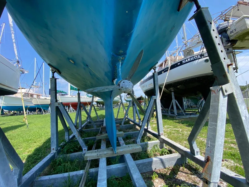 Slide: The Image of Ericson 39 Flushdeck sailboat from 1972 on metal stands, viewed from below. - 17
