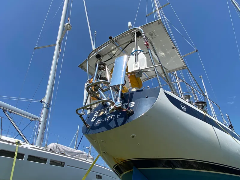 Slide: The Image of 1972 Ericson 39 Flushdeck sailboat in Seattle marina, blue sky background. - 18
